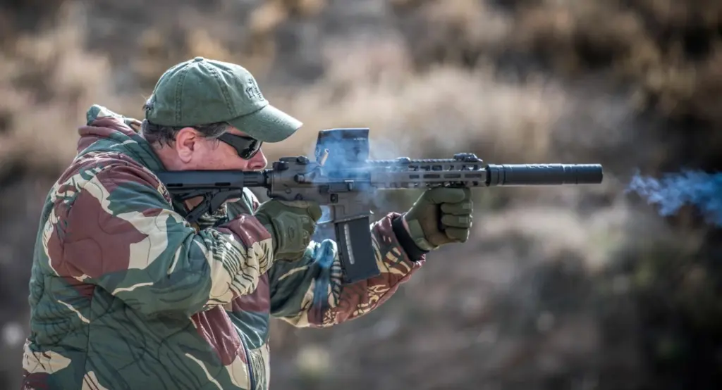 Man shooting a suppressed AR-15 with subsonic ammo
