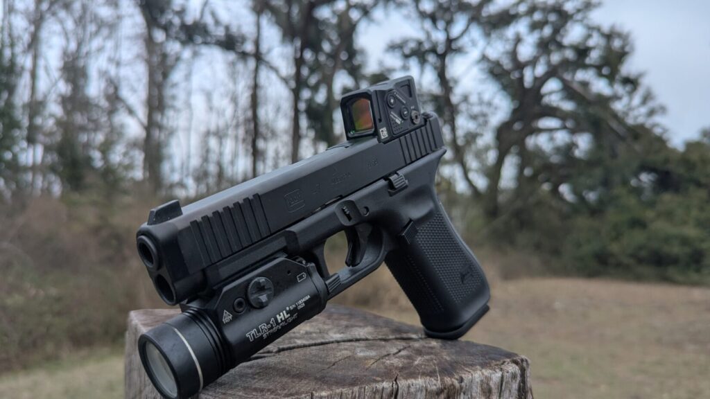 Front perspective of the Glock 47 Gen 5, highlighting the enclosed emitter of the Aimpoint COA and the Streamlight TLR-1 HL.