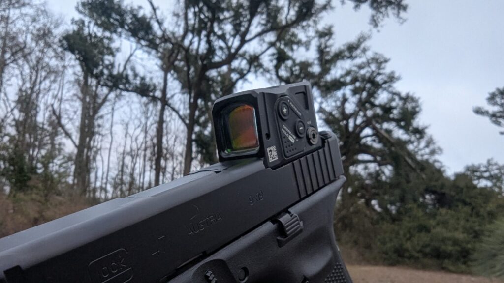 Profile of the Aimpoint COA enclosed emitter sight, emphasizing its rugged aluminum housing and minimal height over bore.