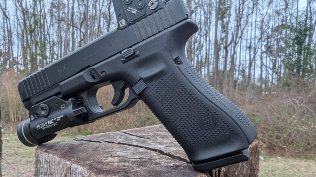 Rear three-quarter view showing the Aimpoint COA’s slim housing and the A-CUT mounting interface integrated into the Glock 47 slide.