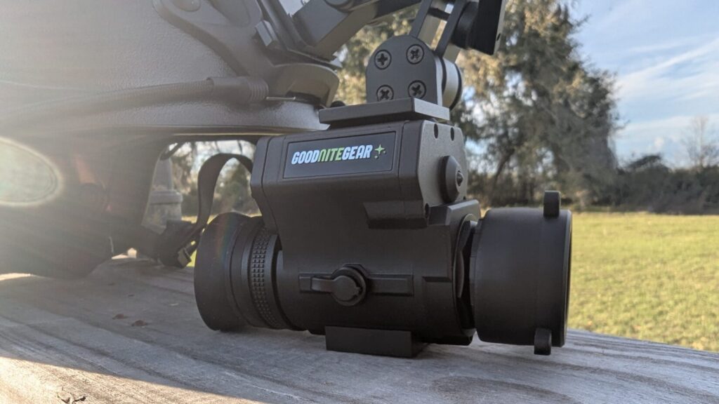 A close-up of the device mounted on a helmet, showing the side control panel and the "USB/SD" weather-sealed rubber flap.