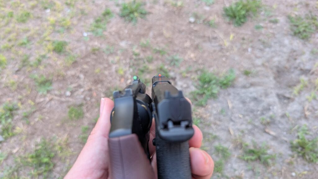 A top-down sight picture comparison between a revolver with a green fiber optic front sight and a Bodyguard 2.0 with an orange front sight.