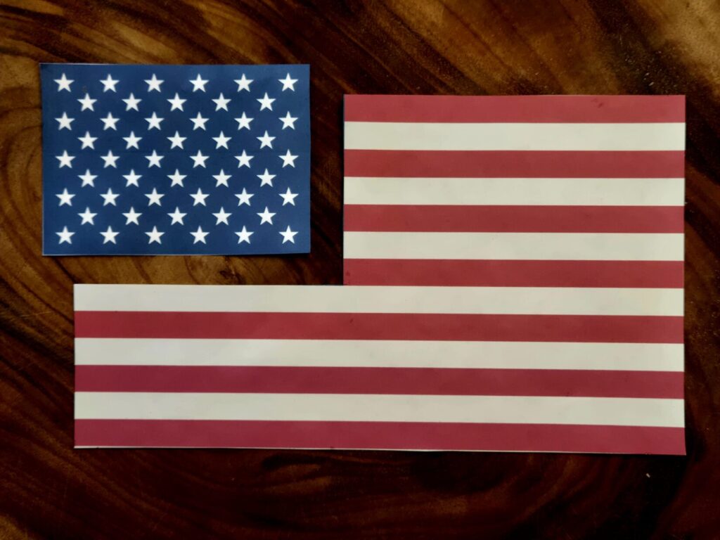 A panel of stars and a panel of stripes on a wood background