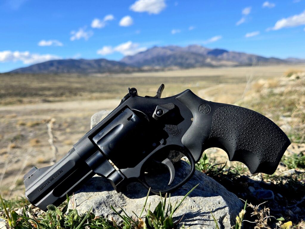 A black revolver on a rock in the high desert of Utah