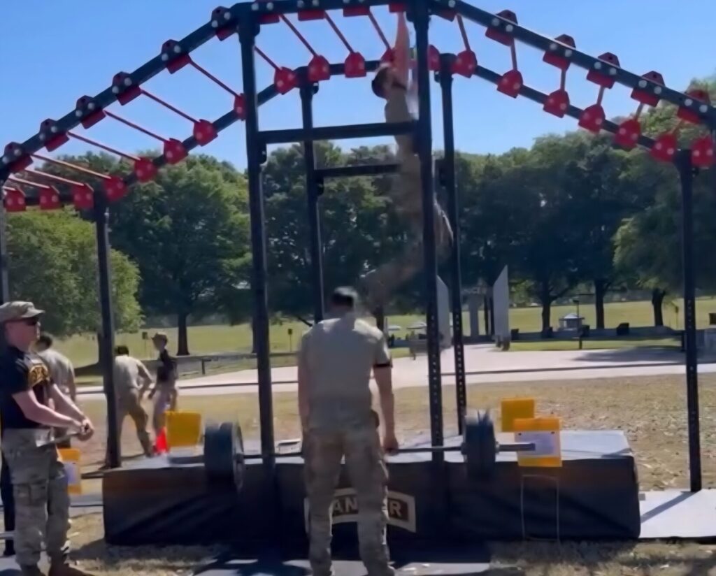 Two men lift weights and climb monkey bars while another judges