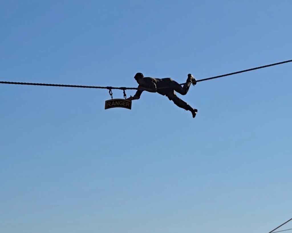 a man crossing a line reaching out to a sign