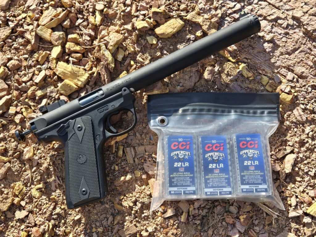A pistol with a water resistant bag with spare boxes of ammunition