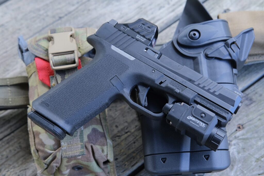 Ruger RXM in a full size black grip frame with holosun SCS320- and Nightstick TCM-10-T on top of a Safariland Ballast Duty holster