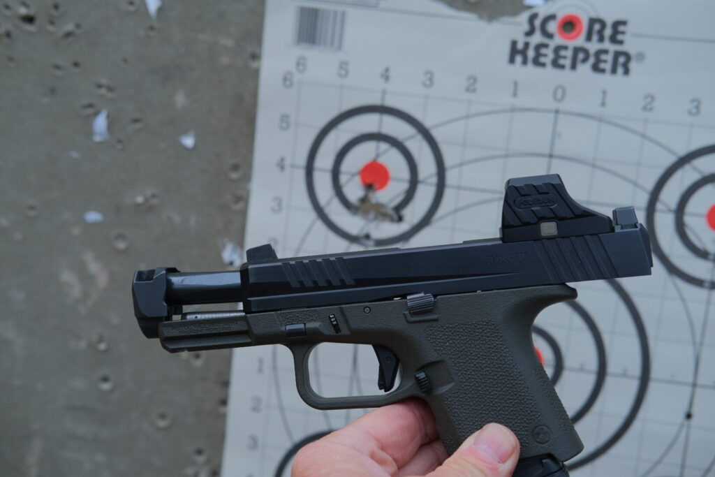 Ruger RXM with a Holosun SCS320 and Radian Ramjet and Afterburner, installed in a green subcompact frame.