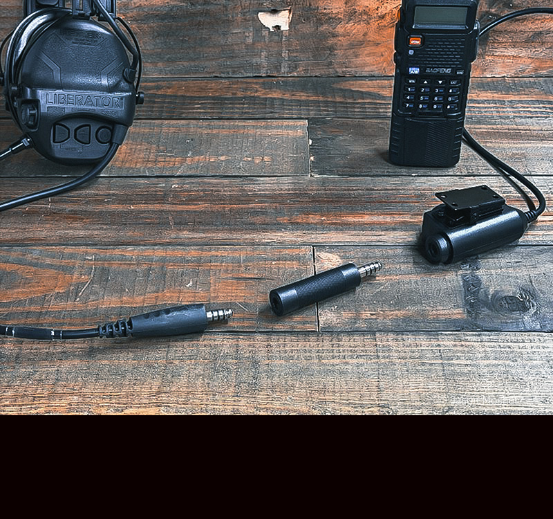 A wire from the headset on a table with an adaptor between that and the PTT for the radio.