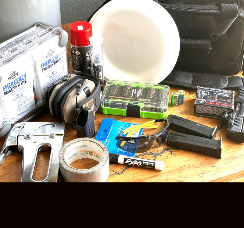 Random gear for a range bag laid out on a table. 