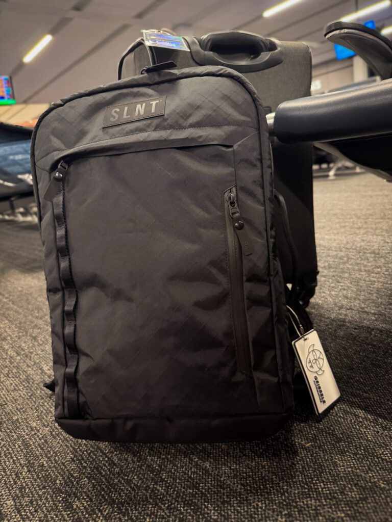 Black backpack on the floor with a bright background