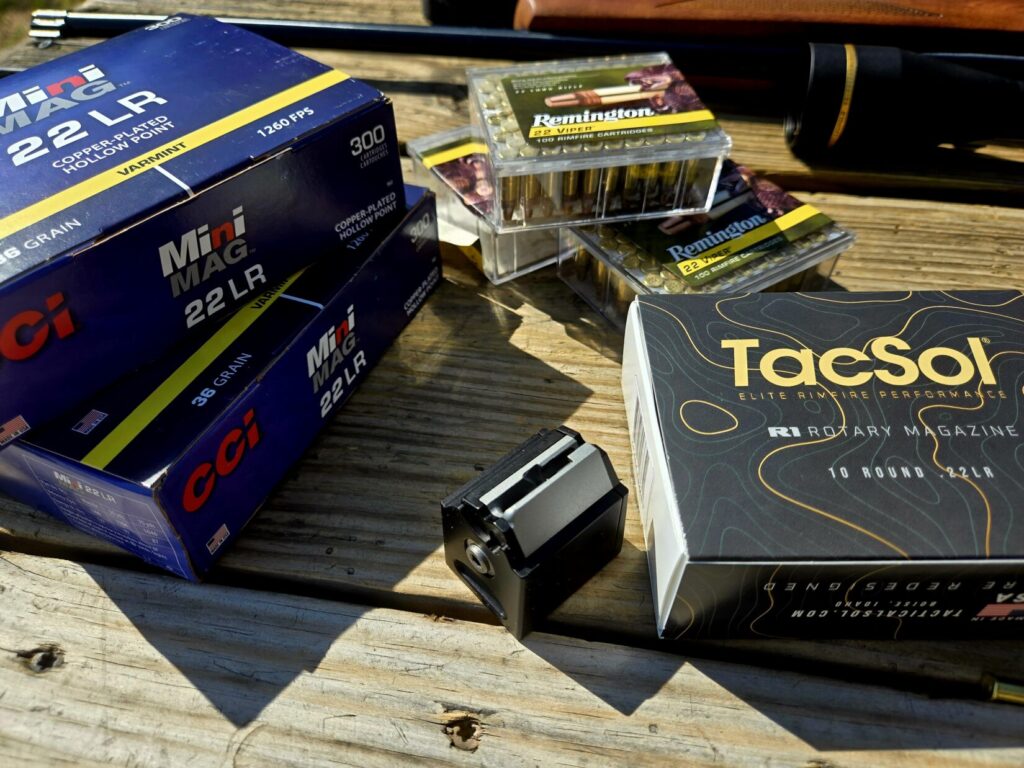Ammunition on a table along with a rotary magazine.