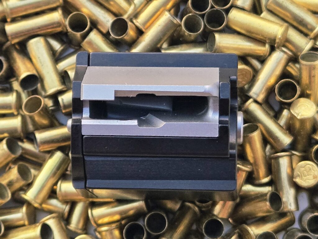 A rifle magazine on top of spent 22 casings