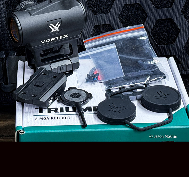 An image of the Triumph red dot on the box it was shipped in with all the accessories laying around it. 