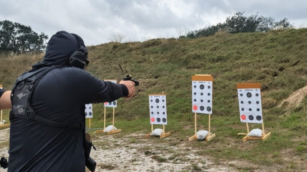 Man shooting target with mtuliple targets at outdoor range
