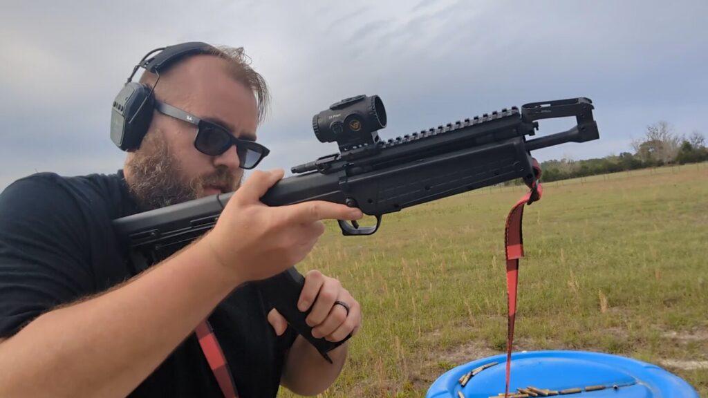 A head-on shot of the shooter reloading the rifle