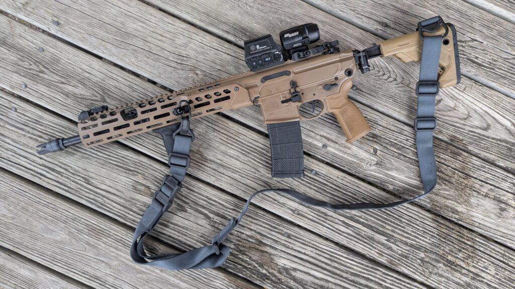 The MS1 sling draped over the receiver and stock of a rifle resting on a wooden deck.