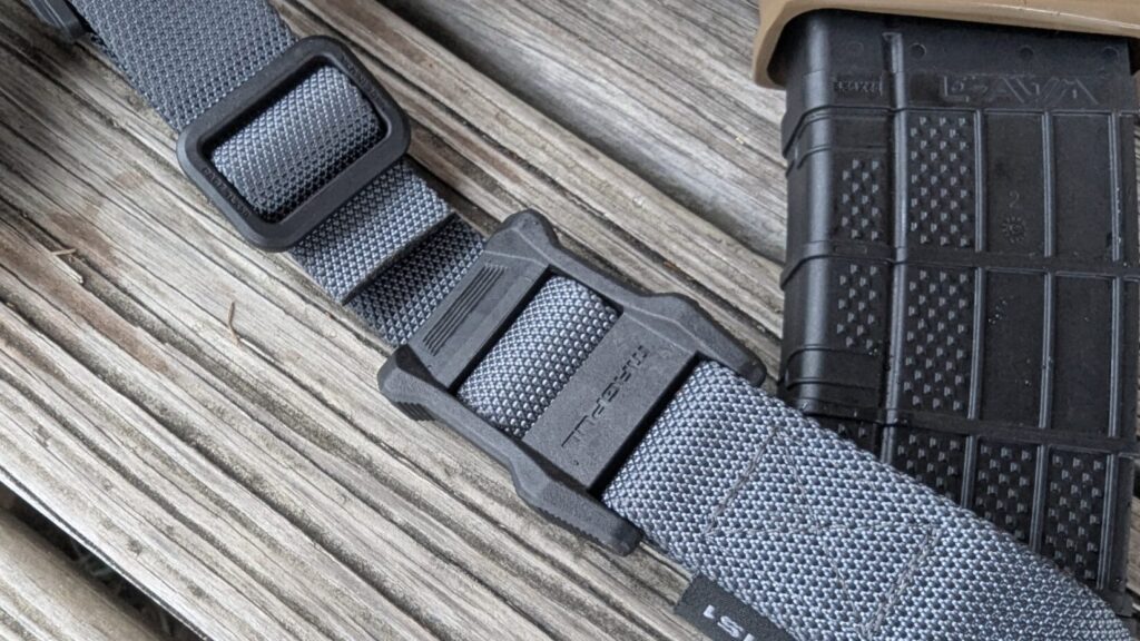 A detailed view of the low-profile Magpul MS1 adjustment slider on the grey webbing.