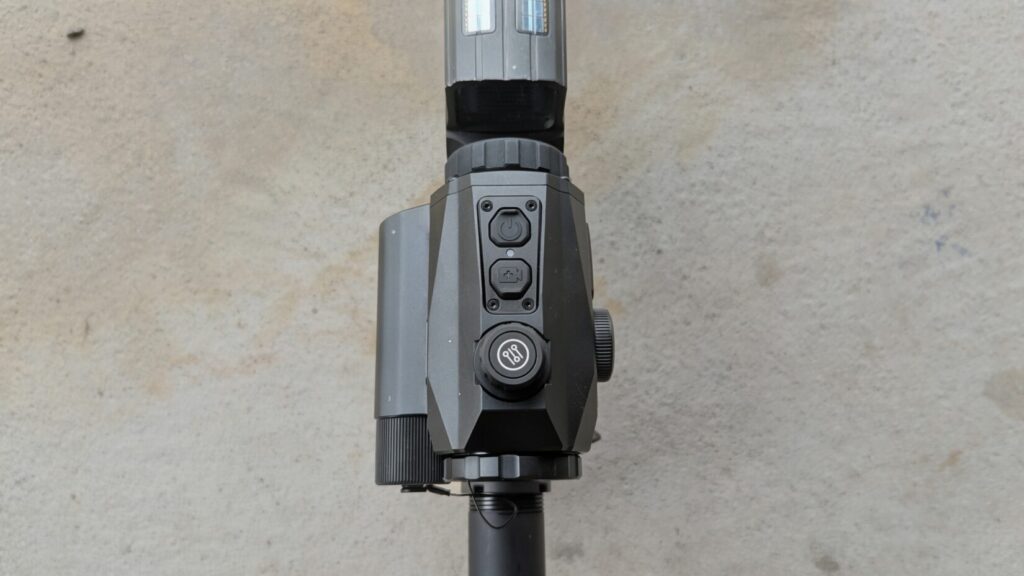 High-angle shot of the NVMD-C200 positioned behind a Holosun optic on an AR-15 upper receiver.