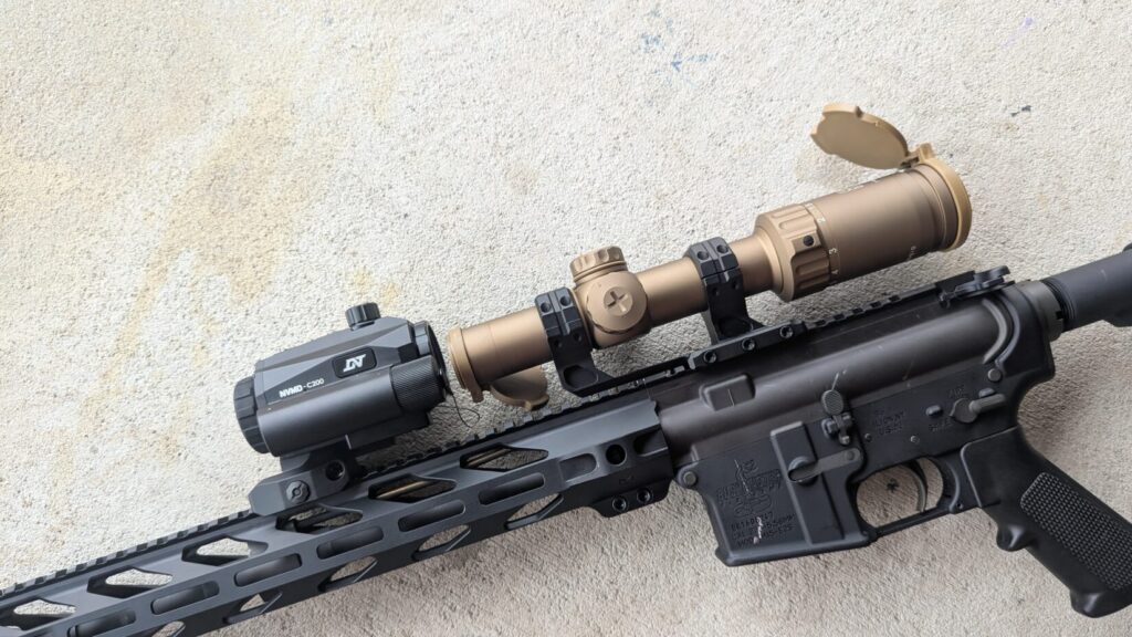 Side view of the NVMD-C200 mounted "clip-on" style in front of a tan low-power variable optic (LPVO).