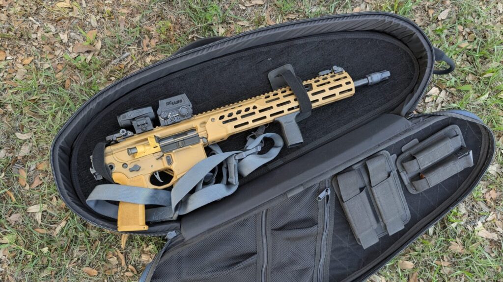 Open Savior Pro Touring case showing a tan Sig Sauer MCX rifle secured inside with various gear pouches.