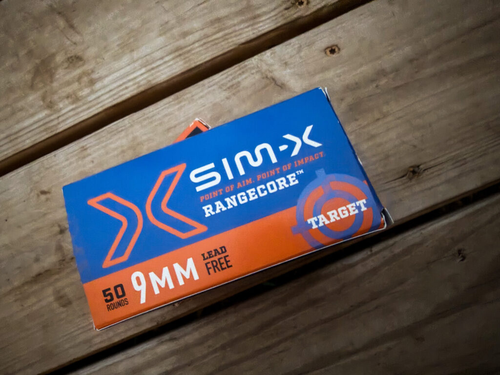 blue box of handgun ammo on a wood background