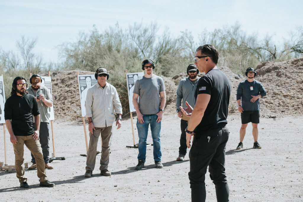 Man in a black shirt on a desert landscape.