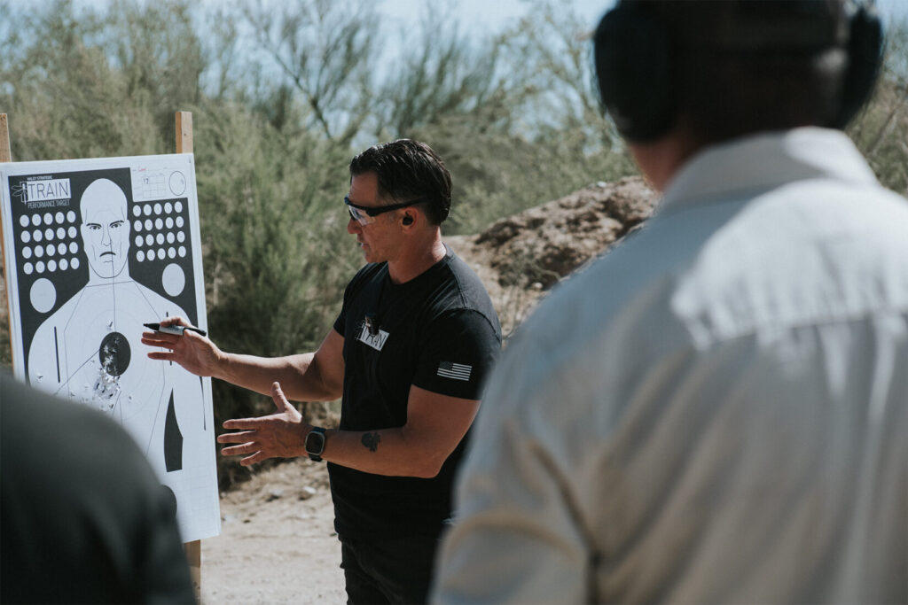 Man in a black shirt on a desert landscape.