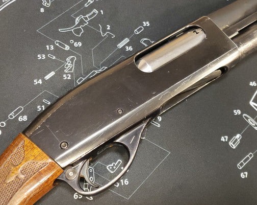 A shotgun on a padded mat