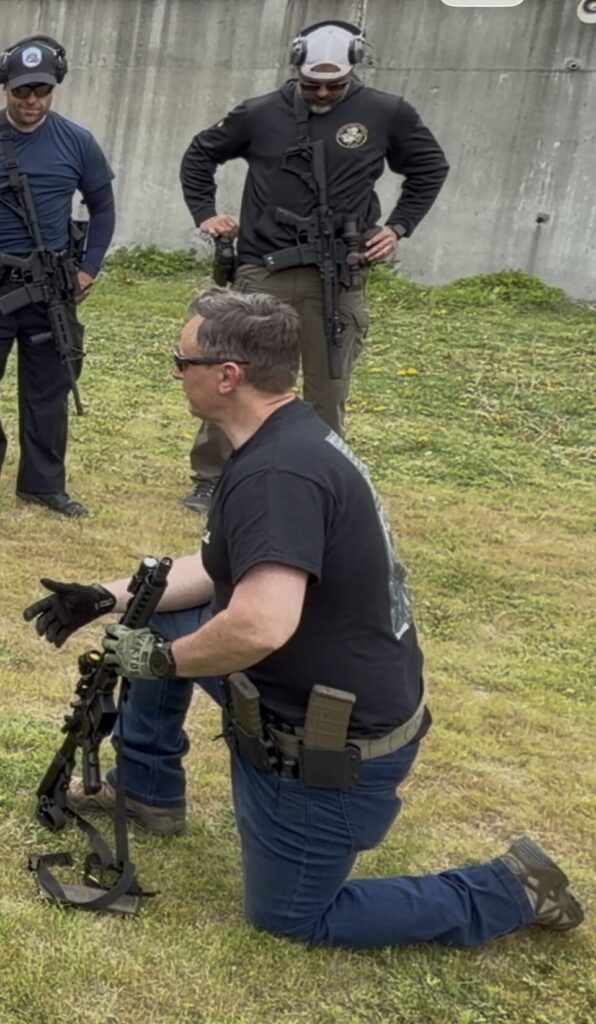 man with rifle, kneeling in Viktos Operatus CCW Jeans