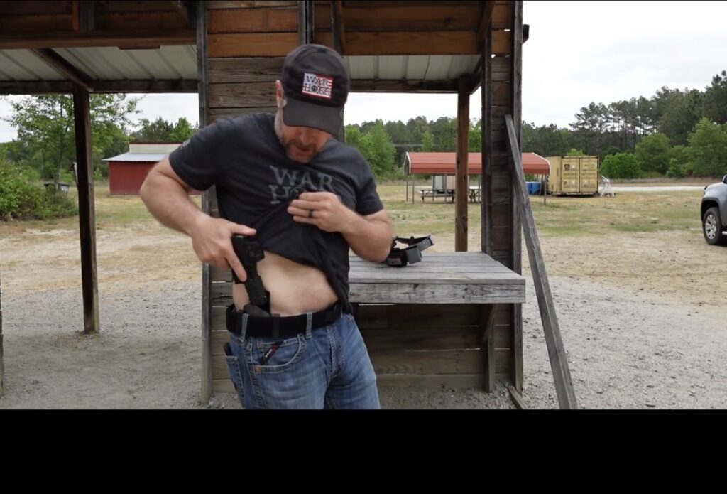 Pictured is Rick Hogg of War HOGG Tactical reholstering on the strong side concealed carry.
