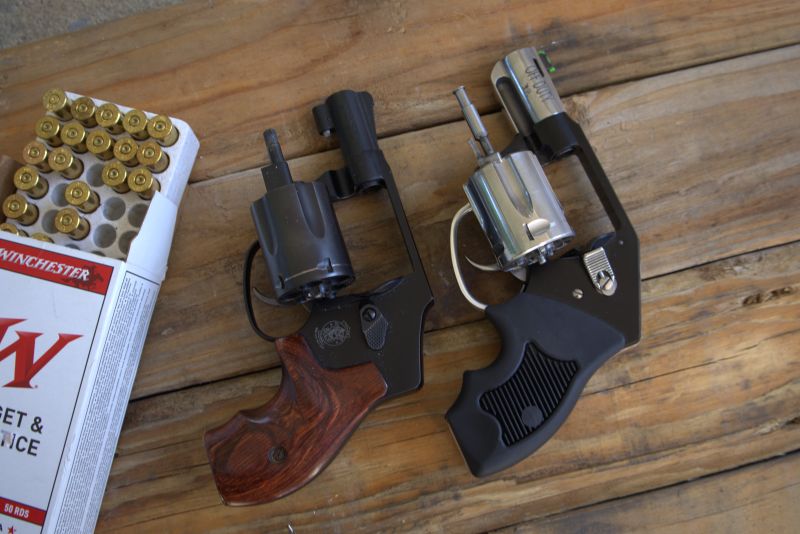 charter undercover revolver next to a smith and wesson airweight and a box of ammunition