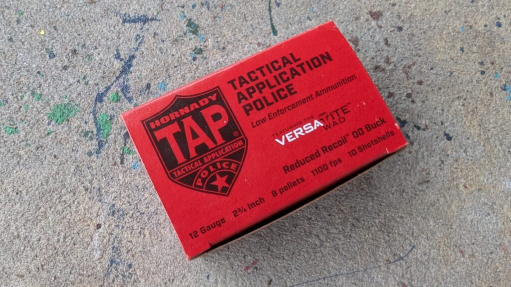 A red box of Hornady TAP Tactical Application Police 12-gauge shotgun ammunition featuring "Reduced Recoil" 00 buckshot.