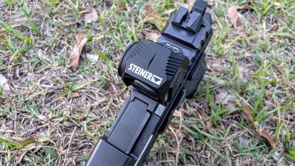 Top-down perspective of the Steiner MPS-C mounted on a pistol slide, clearly displaying the "STEINER" logo and the rear iron sight.