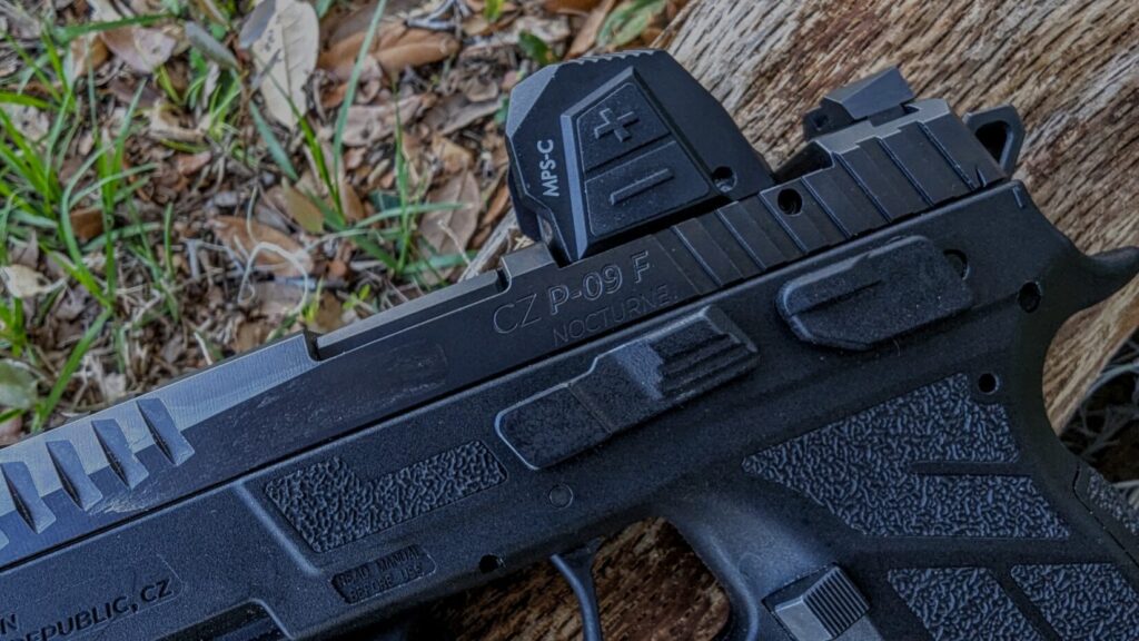 Close-up of the left side of the optic and pistol slide, showing the brightness adjustment buttons and the "CZ P-09 F NOCTURNE" engraving.