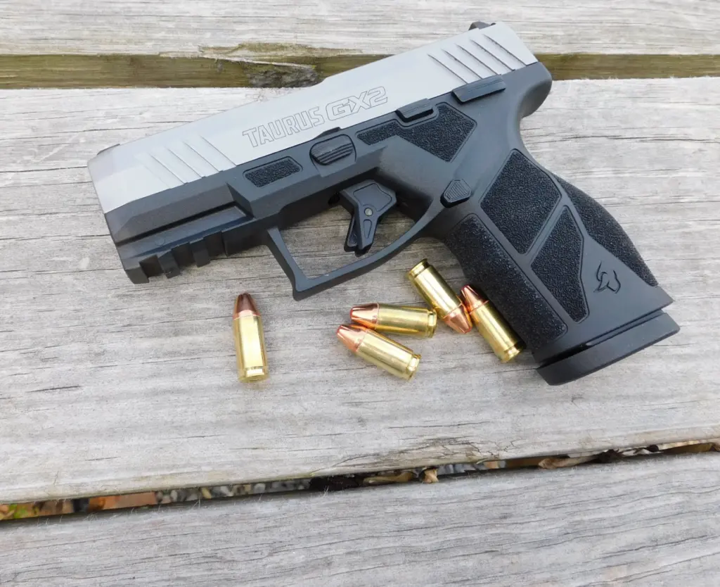 A Taurus GX2 pistol with ammunition cartridges