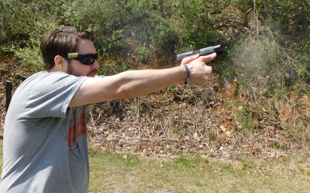 Man shooting a Taurus GX2 pistol, which is ejecting the spent brass cases.