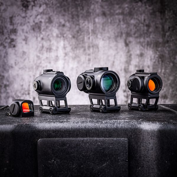 four optics on a grey and black background.