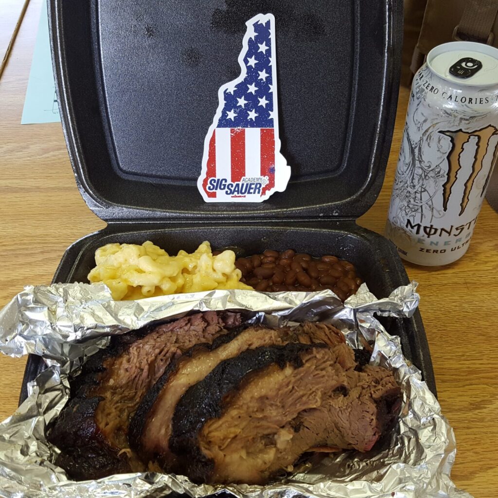 Slices of brisket with macaroni and cheese with beans and a white monster