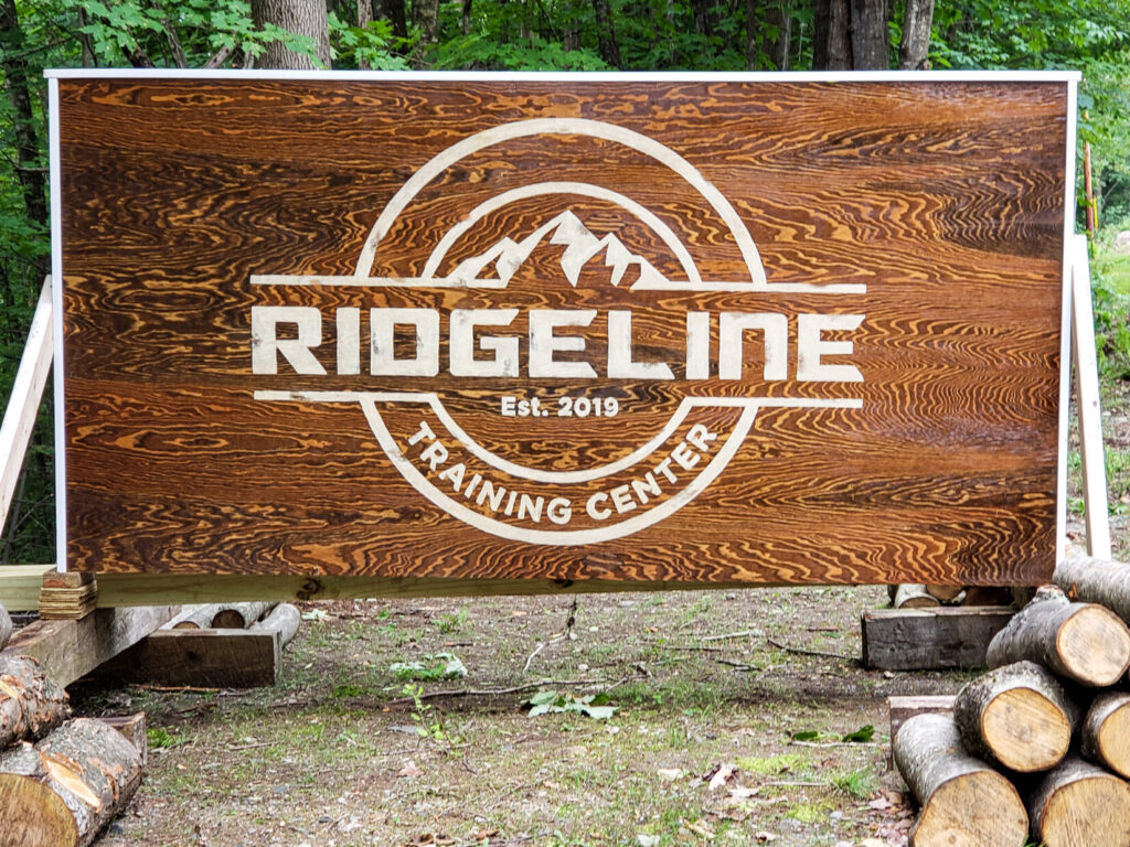 A wooden sign for a training center
