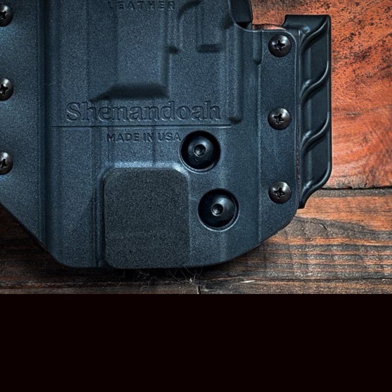 A close up view of the back of the holster, showing the screws used to adjust tension.
