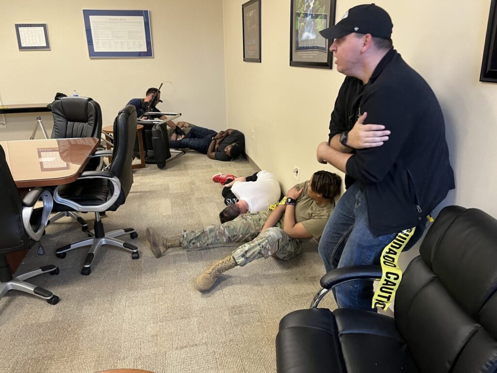 Image of a lone rescuer with an M4 rifle encountering five wounded.