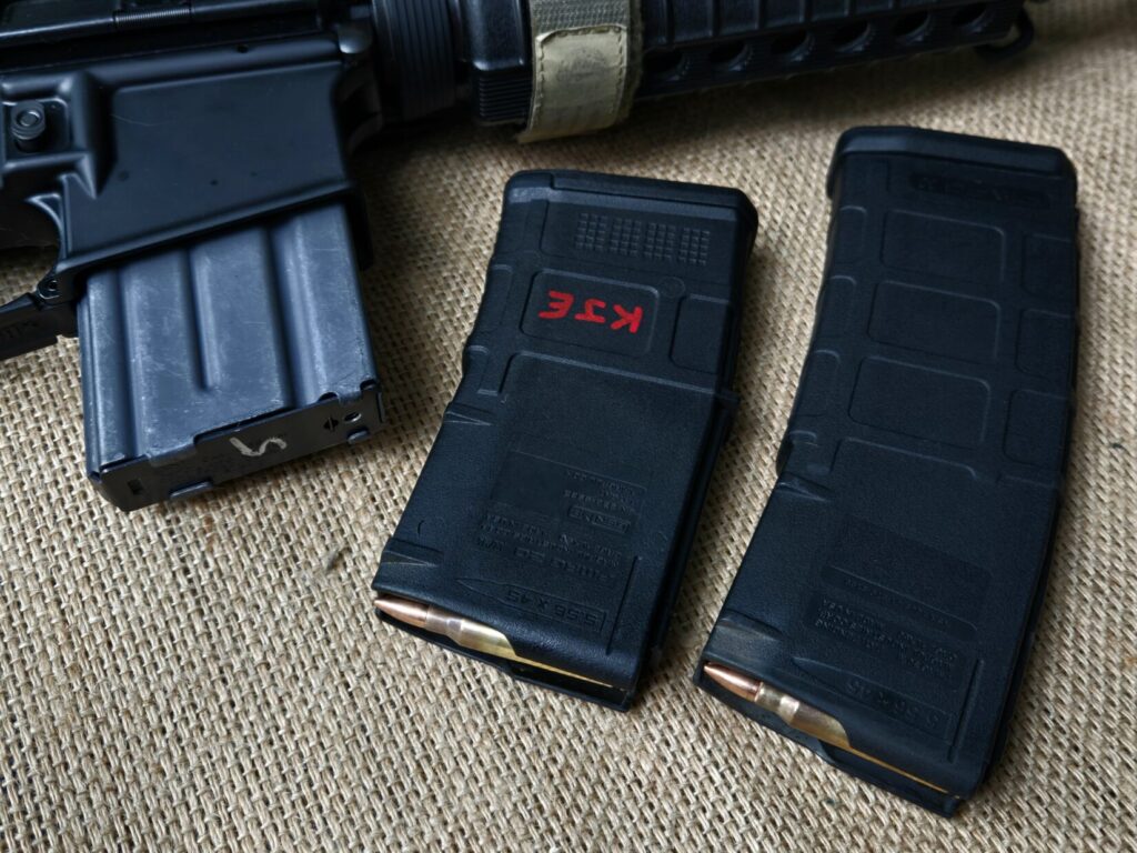 An AR15 loaded with a 20 round magazine and two polymer magazines