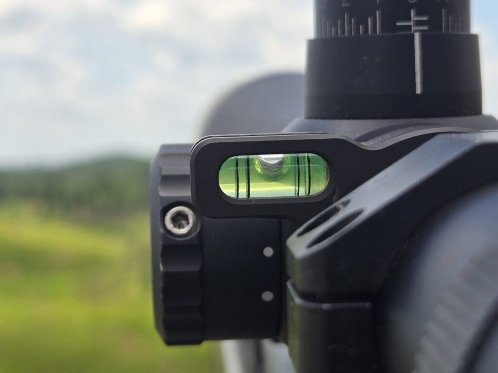 A bubble level on the side of a rifle optic