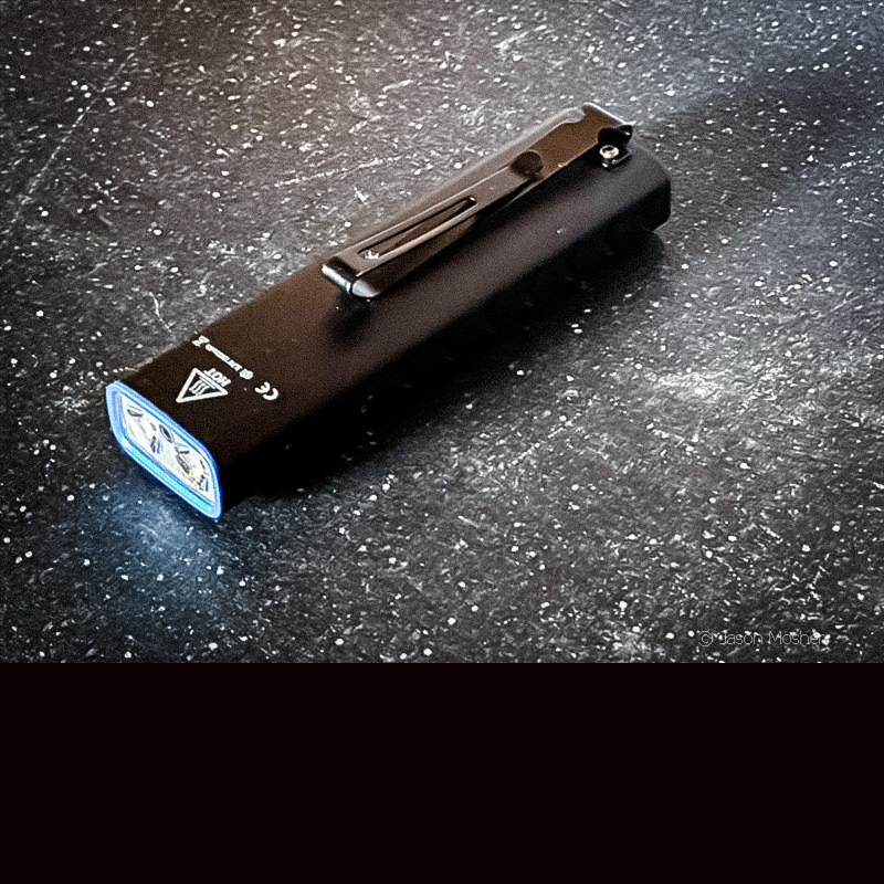 The back side of the TUSK light showing the metal pocket clip attached to it.
