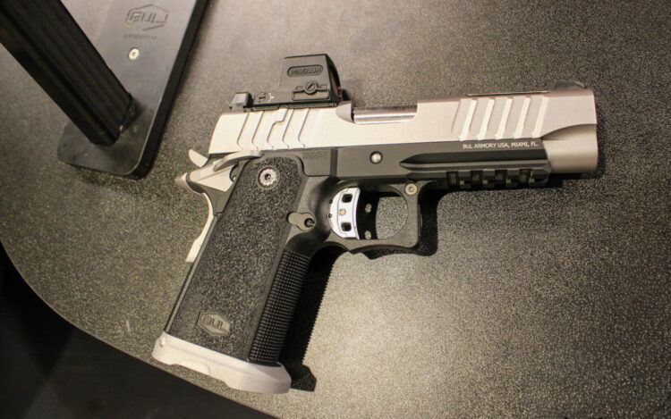 Black and silver pistol on a black background.