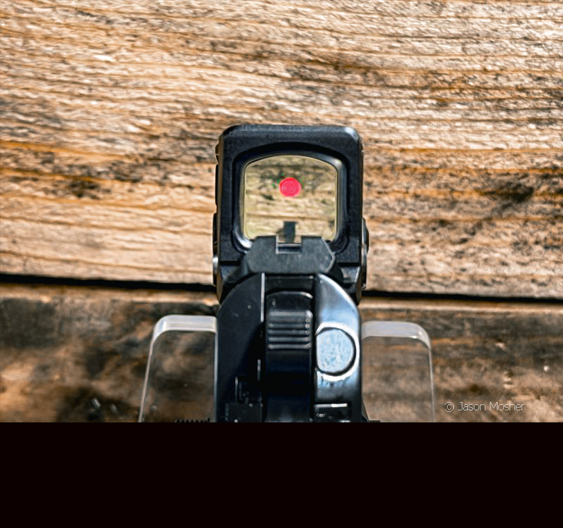 A view looking through the Aimpoint COA red dot on the Prodigy 1911. 