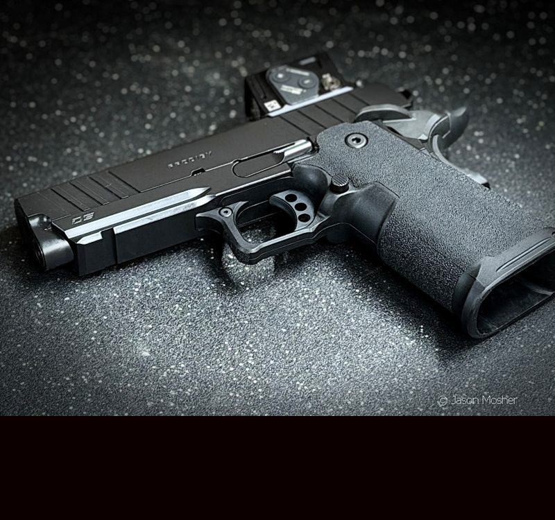 The Prodigy handgun laying on a black surface. 
