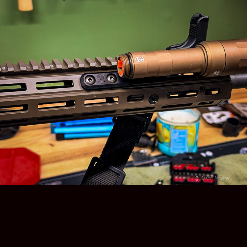 The REIN light attached to a rifle, with the back of the light still missing.